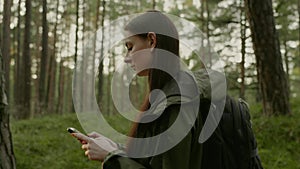 Young attractive woman hiking in a forest