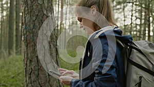 Young attractive woman hiking in a forest