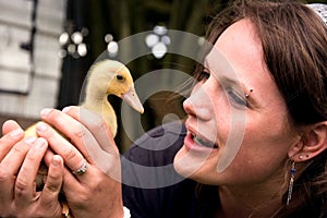 Young Attractive Woman Holding Duckling