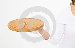 Young attractive woman holding empty wooden tray. Pizza cutting board isolated on white background. Copy space and mock up. Blank