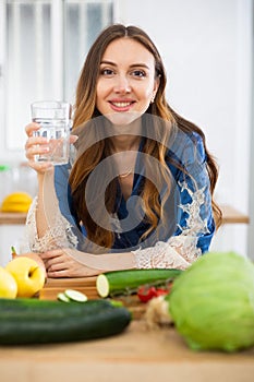 Young attractive woman drinking water at home