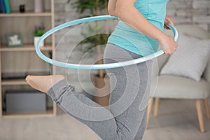 young attractive woman holding hula hoop photo