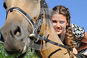 Young attractive woman horseback riding photo