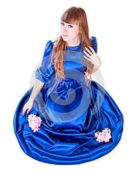 Young attractive woman in a long blue evening dress