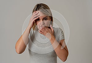 Young attractive woman looking scared, frightened and shocked. Human expressions and emotions