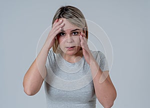 Young attractive woman looking scared, frightened and shocked. Human expressions and emotions