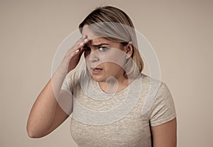 Young attractive woman looking scared, frightened and shocked. Human expressions and emotions