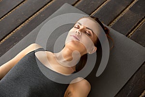 Young attractive woman lying in Dead Body exercise