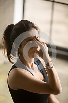 Young attractive woman making Alternate Nostril Breathing, studi