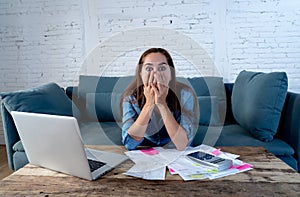 Young attractive woman managing paying bills and calculating finances felling stressed and worried