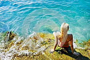 Young attractive woman near the water