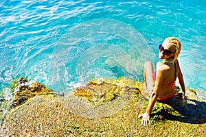 Young attractive woman near the water