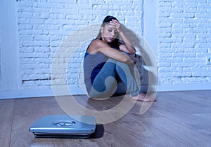 Young attractive woman obsessed with weight looking at scale