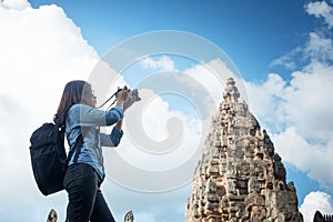 Young attractive woman photographer tourist with backpack coming