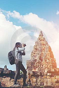 Young attractive woman photographer tourist with backpack coming