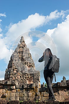 Young attractive woman photographer tourist with backpack coming