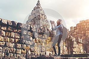 Young attractive woman photographer tourist with backpack coming