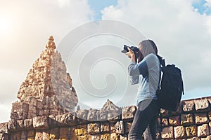 Young attractive woman photographer tourist with backpack coming