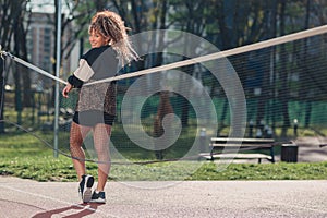 Young attractive woman posing on a volleyball sand court