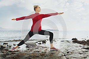 Young Attractive Woman Practicing Yoga On The Beach. Biohacking, Meditation, Mental Health Concept