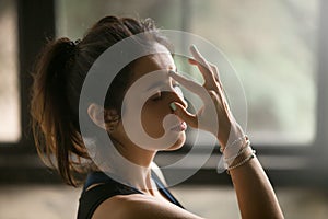 Young attractive woman in Alternate Nostril Breathing, studio ba photo