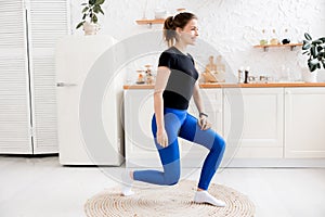 Young attractive woman practicing yoga, press ups.Plank pose, working out, wearing sportswear, grey pants, blue bra