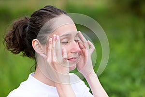 Young attractive woman practising yoga in a park