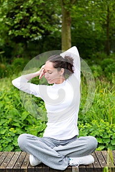 Young attractive woman practising yoga in a park