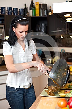 Young attractive woman preparing lunch