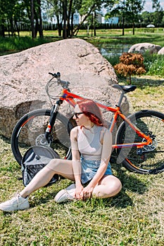 Young attractive woman is resting after bicycle ride. Active lifestyle, sports