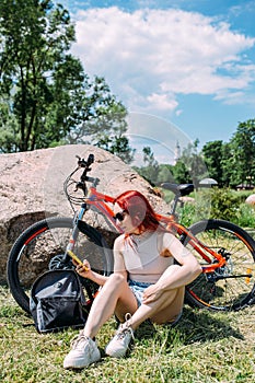 Young attractive woman is resting after bicycle ride. Active lifestyle, sports