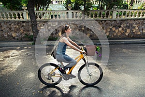 Young attractive woman riding a bicycle.