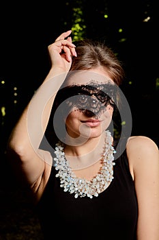 Young attractive woman is wearing the sexy transparent black dress. Young woman modern portrait