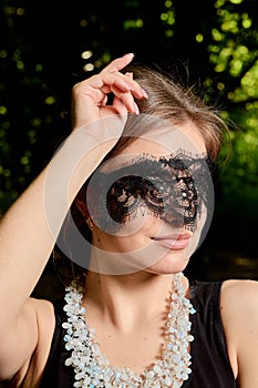 Young attractive woman is wearing the sexy transparent black dress. Young woman modern portrait