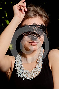 Young attractive woman is wearing the sexy transparent black dress. Young woman modern portrait