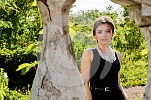 Young attractive woman in the sexy transparent black dress. Young woman portrait