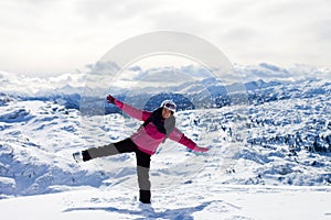 Young attractive woman, skiing in Austrian ski resort on a sunny