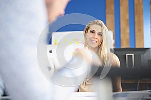 Young attractive woman smile on camera and posing in company office