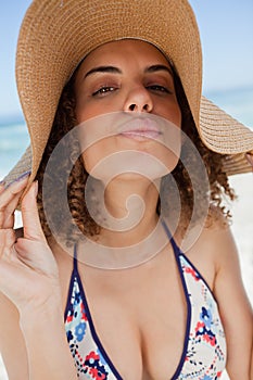 Young attractive woman standing upright with puckered lips photo