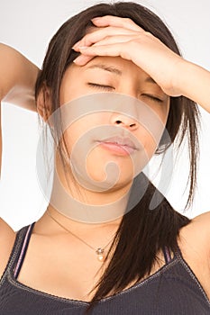 Young attractive woman suffering from headache