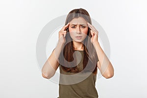 A young attractive woman suffering from illness or headache holding her head. Isolated on white