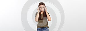 A young attractive woman suffering from illness or headache holding her head.  on white