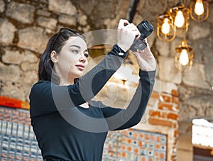 Attractive woman blogger making photos of foreign ancient architecture