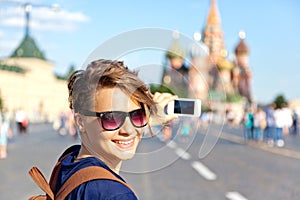 Young attractive woman traveler with backpack on the background