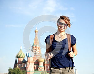 Young attractive woman traveler with backpack on the background