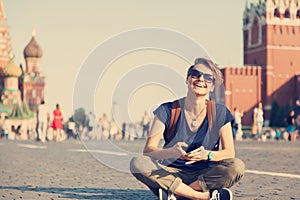 Young attractive woman traveler with backpack and mobile phone o