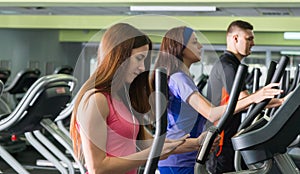 Young attractive woman turning on music while exercising