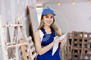 Young attractive woman in uniform makes notes on pape