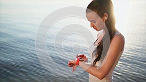 Young attractive woman using her smart watch