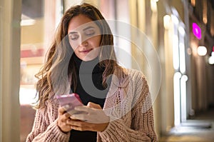 Young attractive woman using mobile phone outdoors